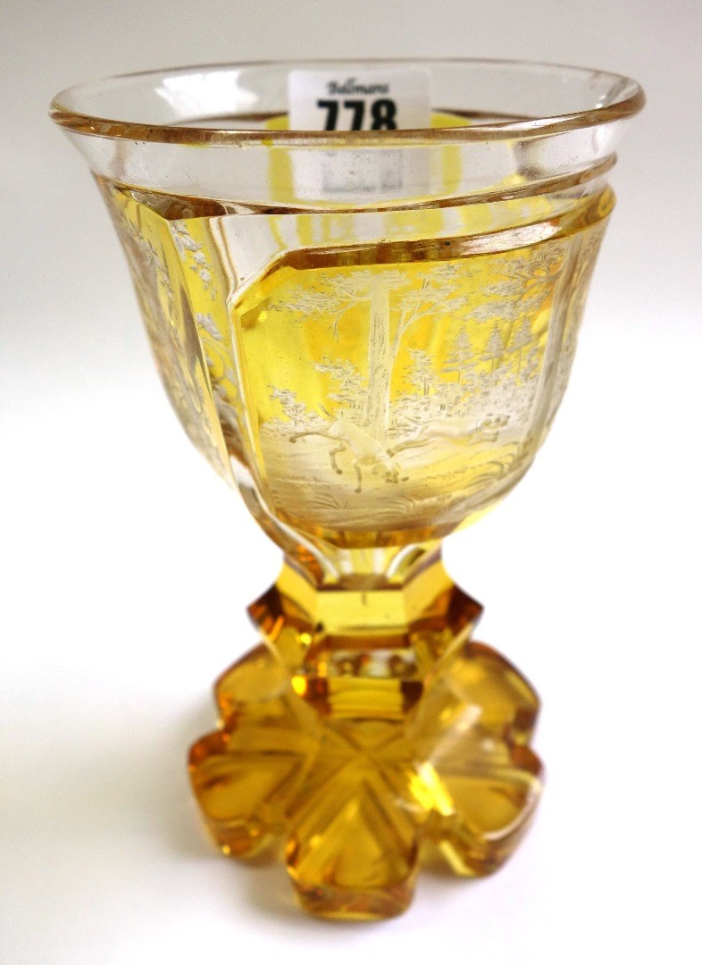 Appraisal: A Bohemian amber etched glass goblet late th century decorated