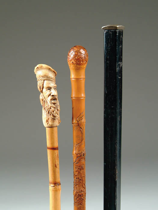 Appraisal: THREE CANES l carved stag handle of an open mouth