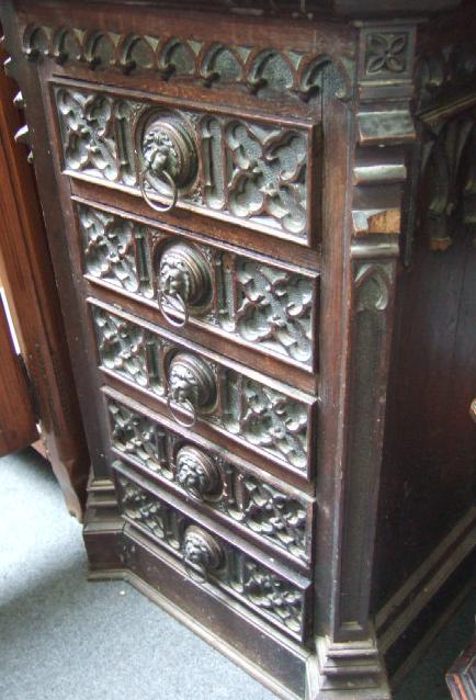 Appraisal: A Victorian carved oak narrow chest with a canted rectangular