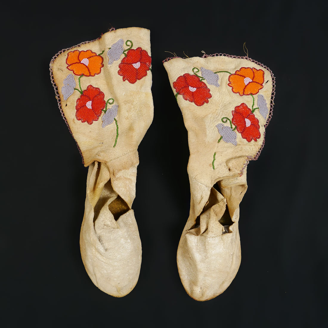 Appraisal: PAIR FLORAL HIGH TOP BEADED MOCCASINS Pair of floral motif