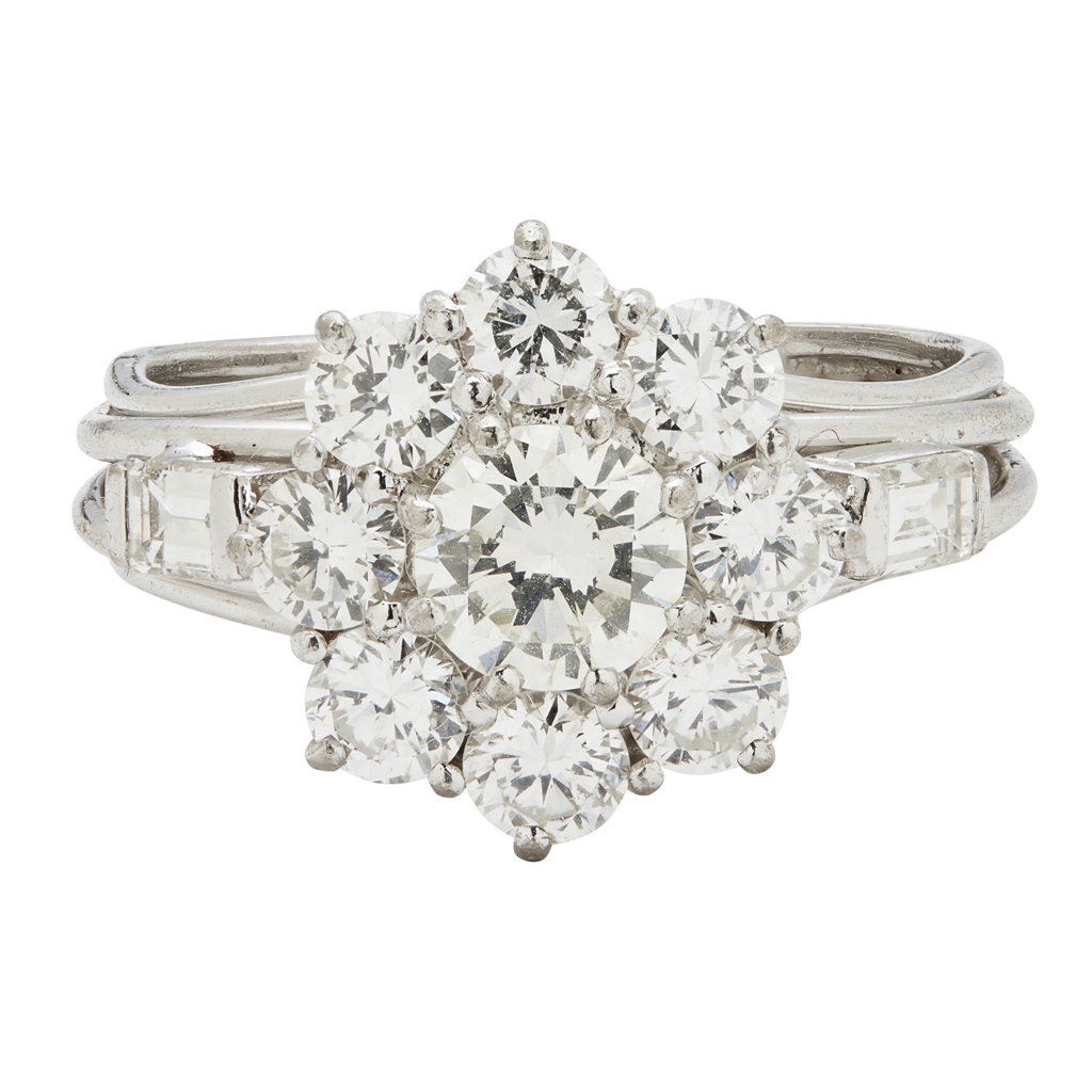 Appraisal: A diamond set cluster ringclaw set with a round brilliant