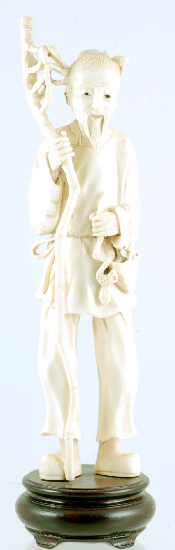 Appraisal: A Japanese carved ivory figure of a peasant man with