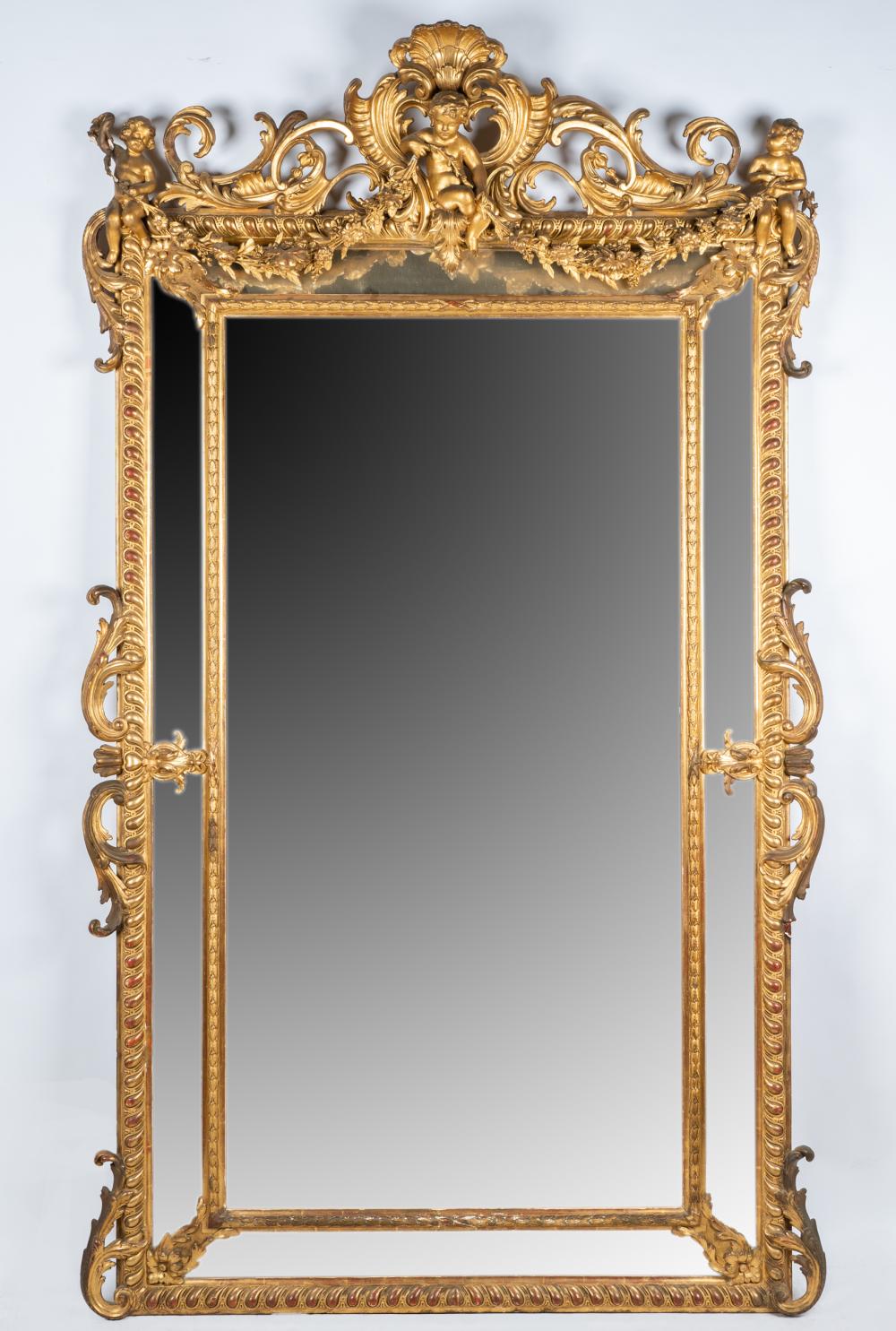 Appraisal: GILTWOOD WALL MIRRORthe cherub and shell surmount over a rectangular