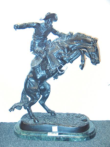 Appraisal: A patinated bronze equestrian group The Bronco Buster After Frederic