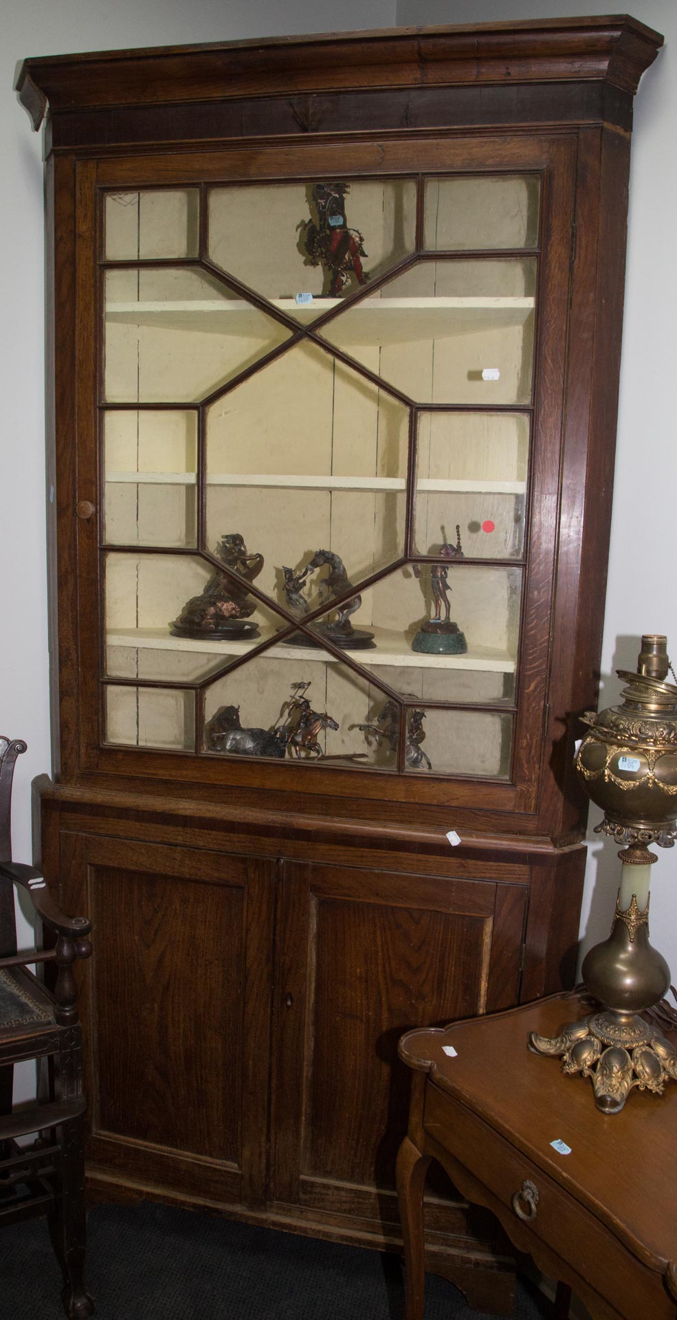 Appraisal: English oak and glass panel corner cupboard