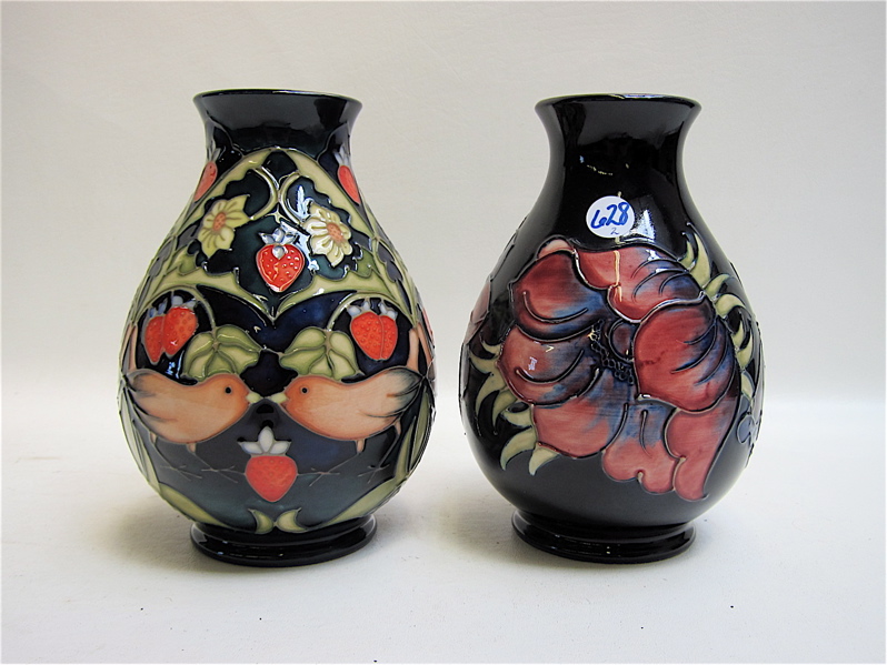 Appraisal: TWO MOORCROFT POTTERY VASES each hand painted under glaze Strawberry