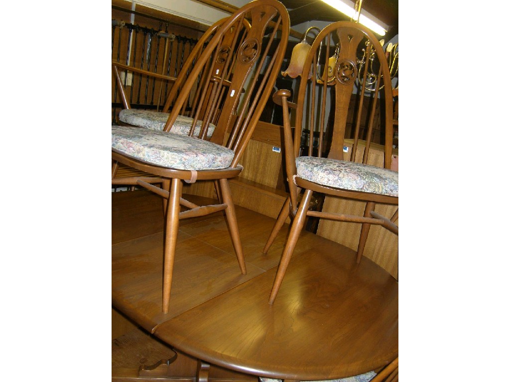 Appraisal: An Ercol elm dining table of oval form with folding