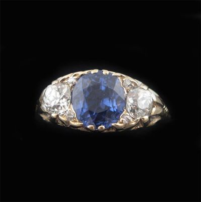 Appraisal: A sapphire and diamond three stone ring the slightly oval