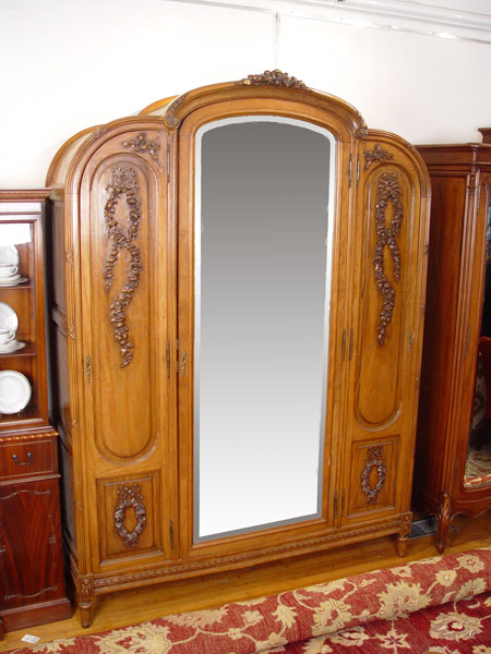 Appraisal: CARVED FRENCH DOOR ARMOIRE Part cabinet with beveled mirror center