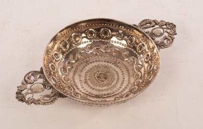 Appraisal: A Dutch silver porringer Amsterdam with twin pierced handles and