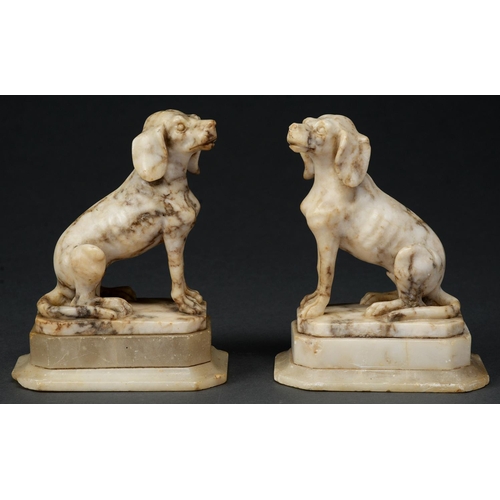 Appraisal: A pair of alabaster sculptures of seated dogs th c