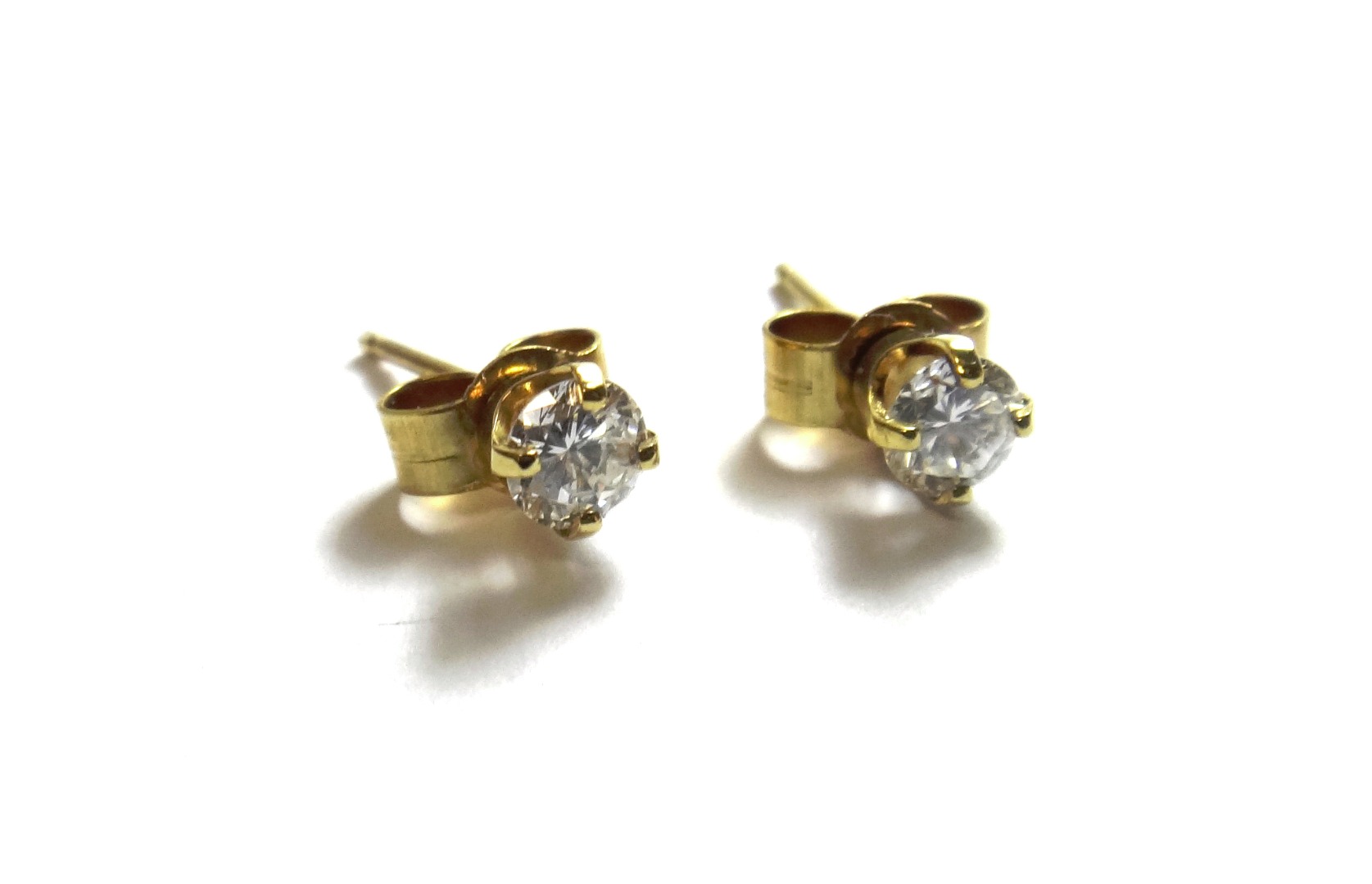 Appraisal: A pair of gold and diamond set single stone earstuds