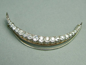 Appraisal: A diamond crescent brooch With claw set graduated diamonds unmarked