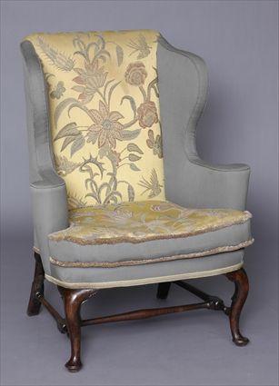 Appraisal: QUEEN ANNE CARVED WALNUT WING ARMCHAIR With shaped wings outscrolled