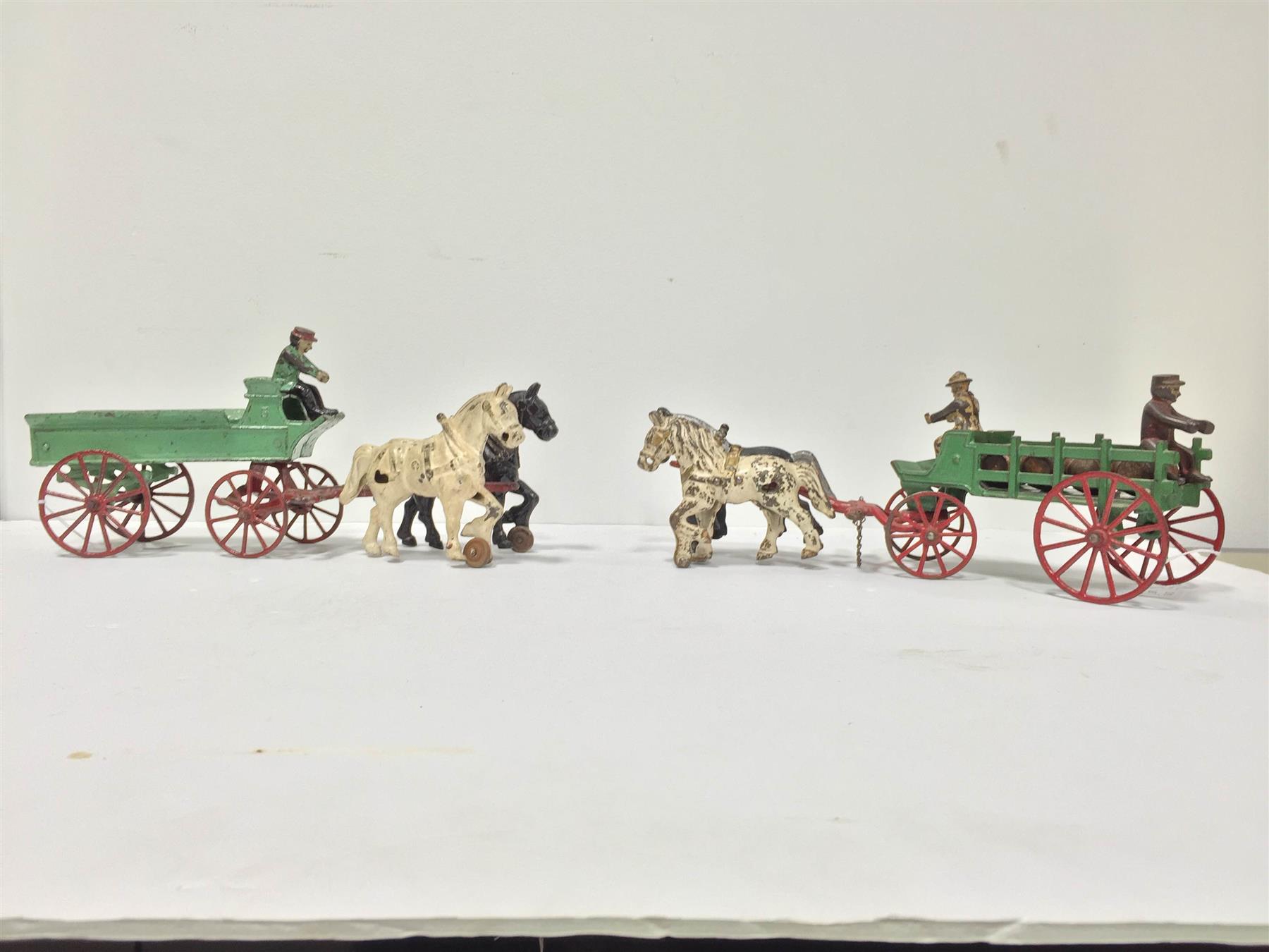 Appraisal: TWO KENTON CAST IRON DELIVERY WAGONS American mid- th century