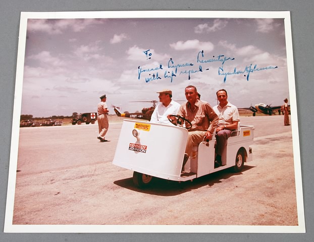 Appraisal: Autographed photograph showing Johnson in golf cart type vehicle at