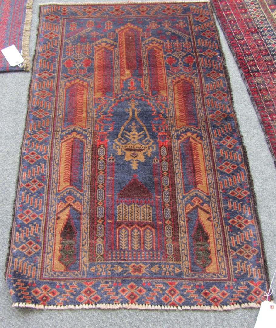 Appraisal: A Beluche prayer rug the indigo mehrab with arch above