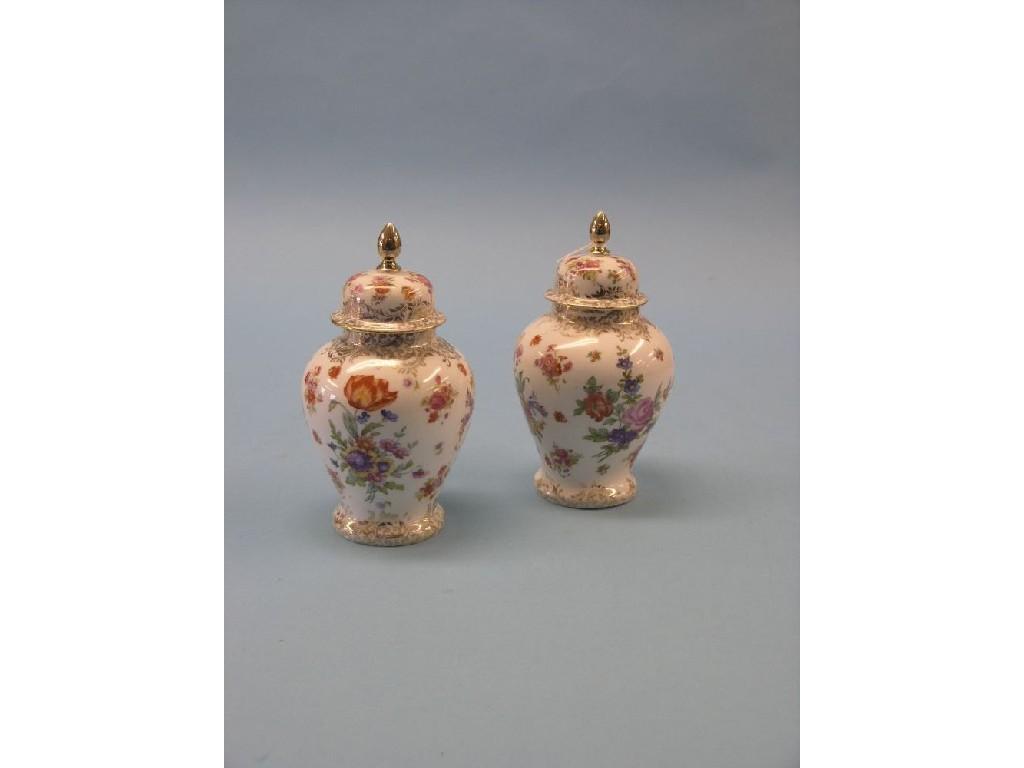 Appraisal: A pair of German porcelain baluster jars each with domed