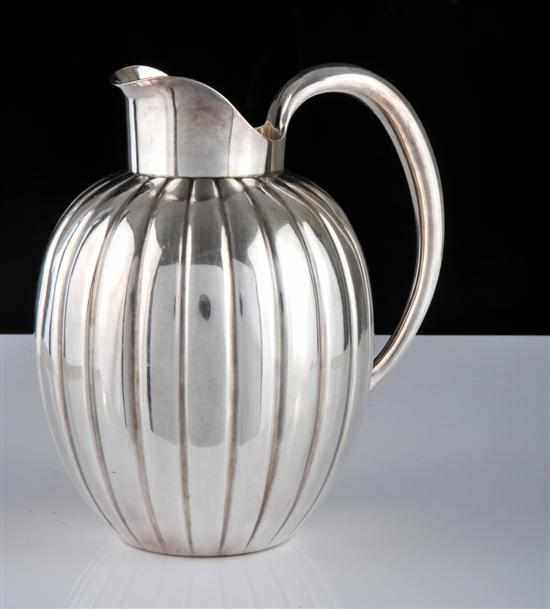 Appraisal: A Georg Jensen sterling silver jug Designed by Sigvard Bernadotte