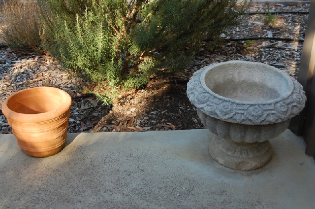 Appraisal: THREE CONCRETE URNS AND TWO TERRACOTTA URNS