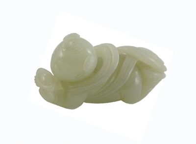 Appraisal: A small celadon jade carving of a prostrate boy holding