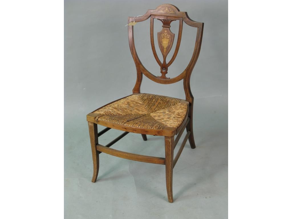 Appraisal: An Edwardian inlaid mahogany nursing chair with shield back and