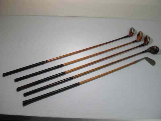 Appraisal: Lot of five assorted wood shaft golf clubs Includes a