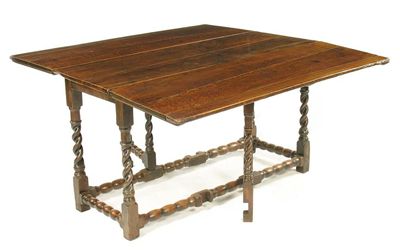 Appraisal: An oak gateleg table the rectangular twin flap top above