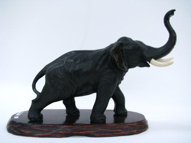 Appraisal: Black painted brass elephant figure hollow with ivory tusks Japanese