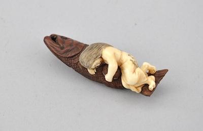 Appraisal: Netsuke of a Sleeping Woman on a Fish Carved ivory