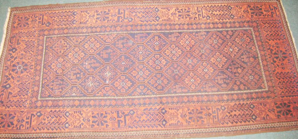 Appraisal: A bordered Afghan Rug with rosettes and stylised animals in