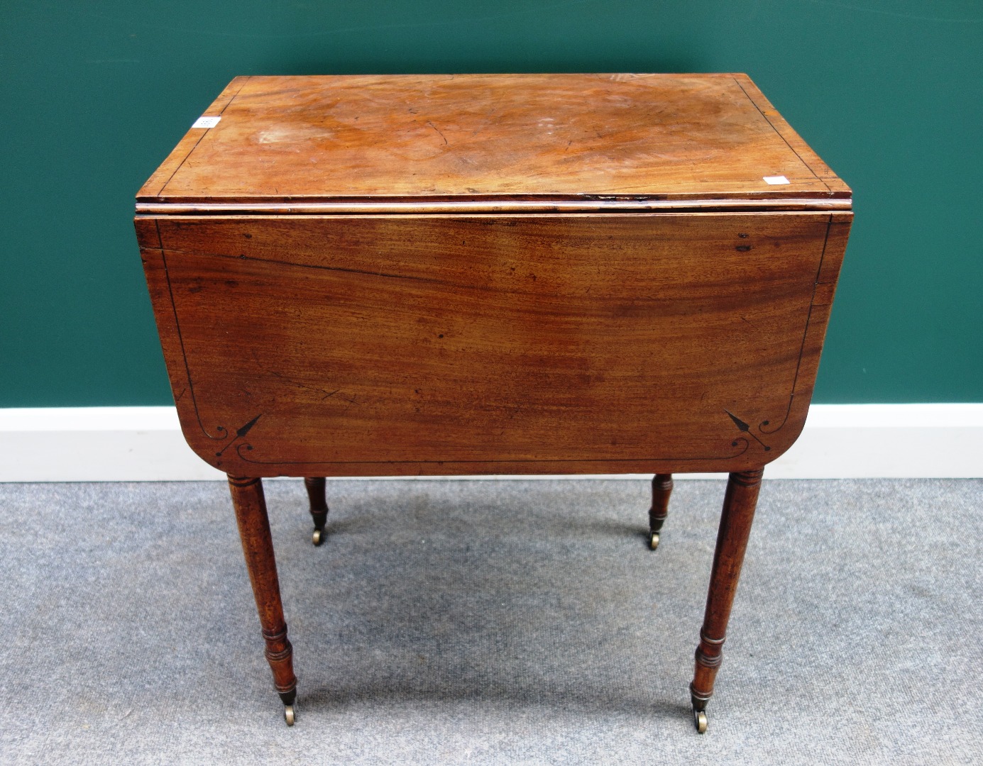 Appraisal: An early th century mahogany drop flap work table with