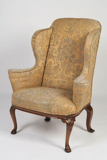 Appraisal: A GEORGE I STYLE WALNUT WING BACK ARMCHAIR the tall