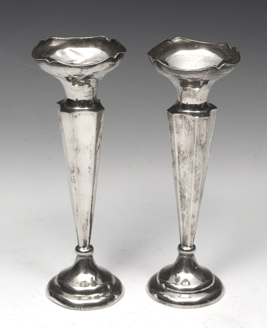 Appraisal: A PAIR OF SILVER TRUMPET VASES standing on a turned