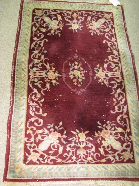 Appraisal: Hand woven wool floral design area rug with maroon green