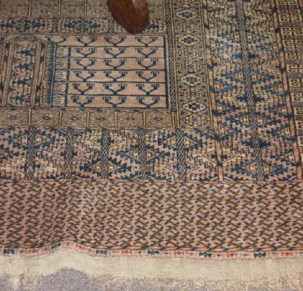 Appraisal: TEKKE TURKOMAN THROW RUG The abrashed salmon field shows an