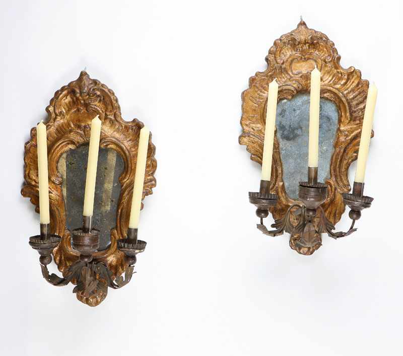 Appraisal: A pair of Italian Baroque style wrought-iron-mounted giltwood girandole mirrors