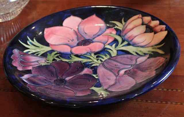 Appraisal: A MOORCROFT DARK BLUE GROUND CHARGER with anenome decoration diameter