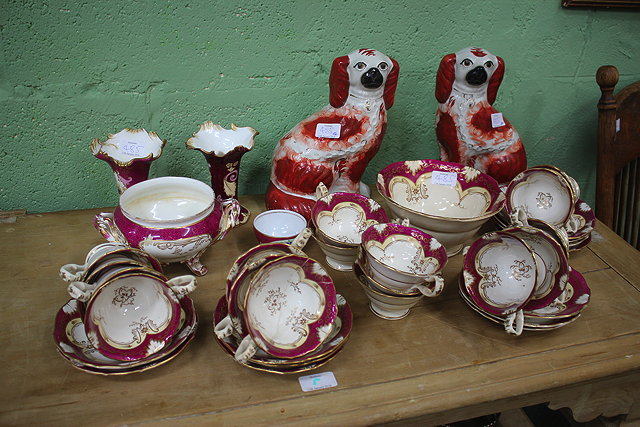 Appraisal: A PAIR OF STAFFORDSHIRE POTTERY SPANIELS cm high