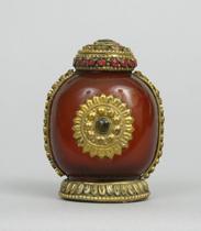 Appraisal: A Sino-Tibetan Snuff Bottle A snuff bottle of carved red