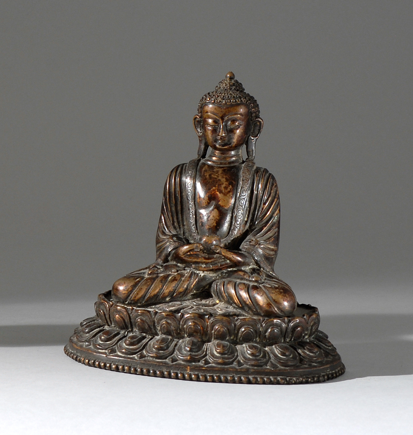 Appraisal: SILVER AND BRONZE FIGURE OF BUDDHA Circa Seated in lotus