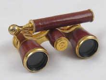 Appraisal: A pair of opera glasses the handle forming a miniature