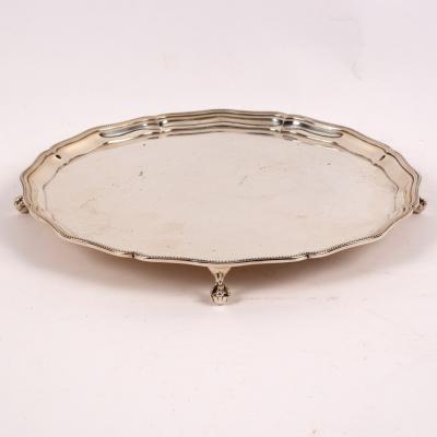 Appraisal: A silver salver Barker Bros Birmingham with beaded wavy edge