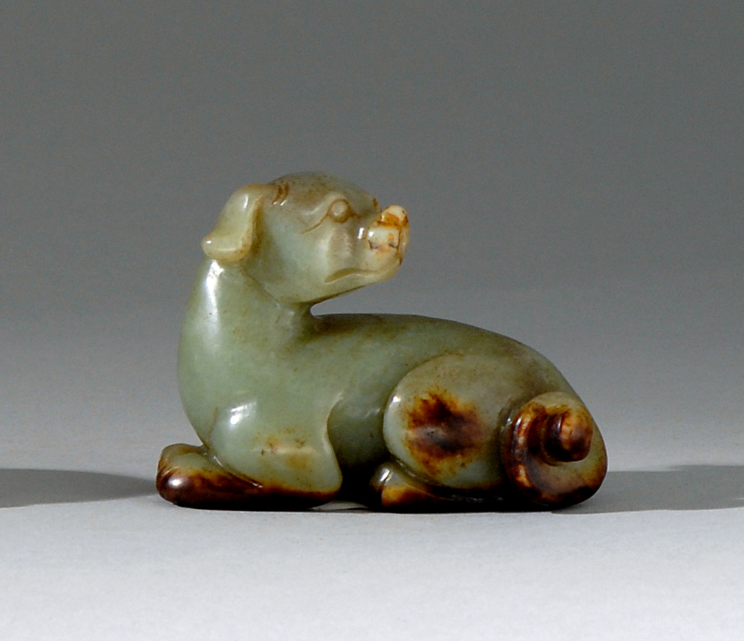 Appraisal: CELADON AND BROWN JADE CARVING In the form of a