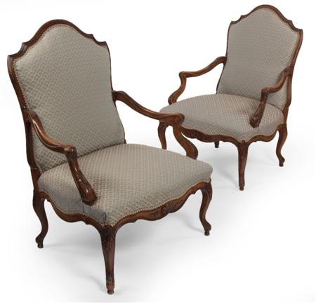 Appraisal: A pair of walnut framed fauteuils each with moulded arched