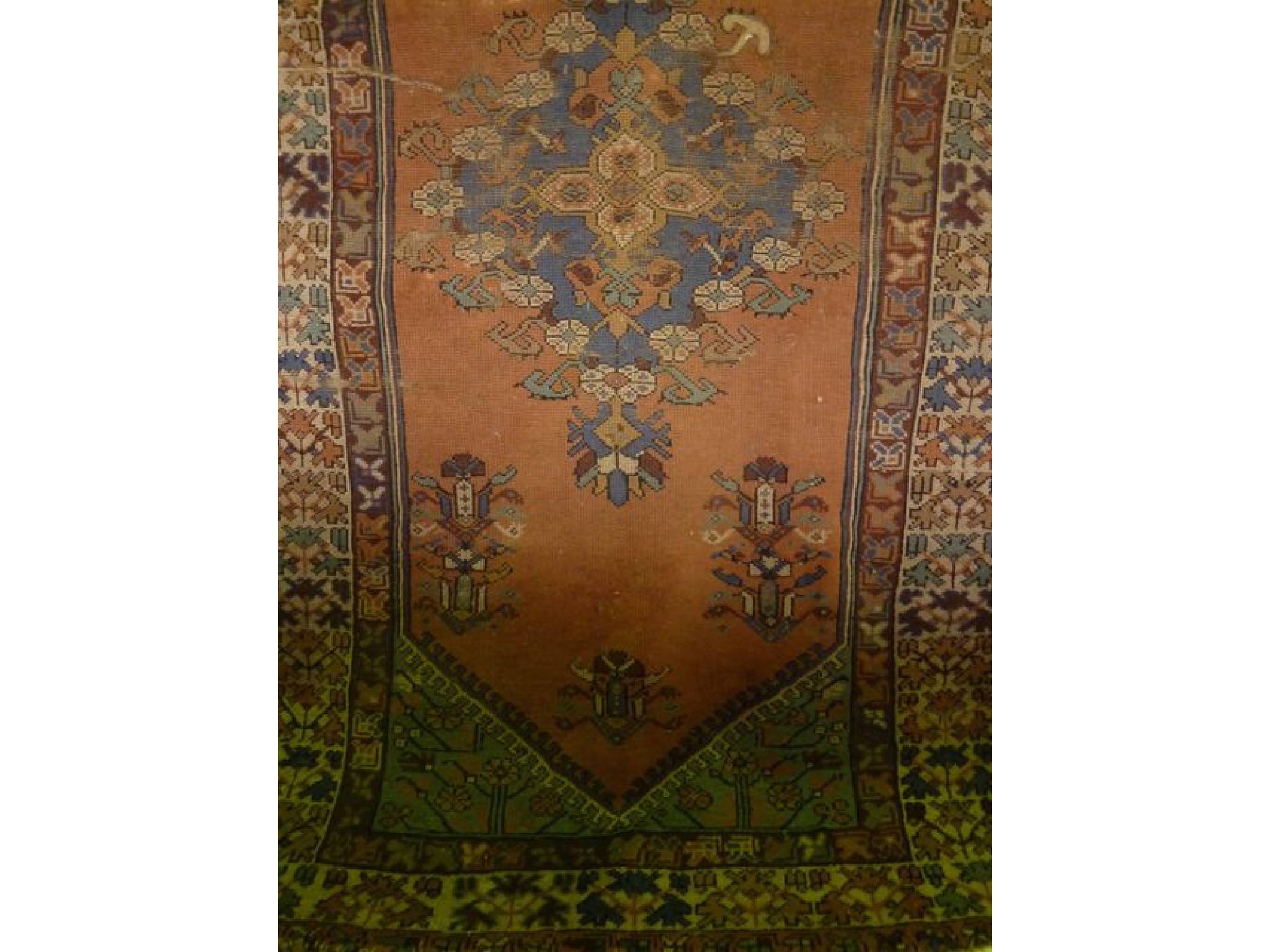 Appraisal: A Persian wool rug with salmon ground field medallion centre