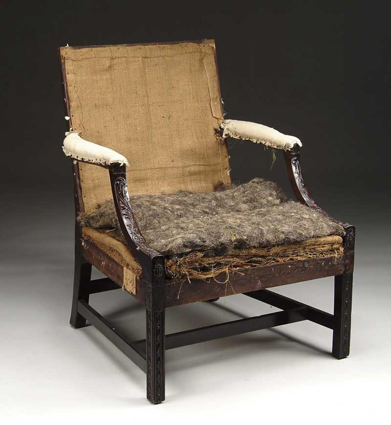 Appraisal: ENGLISH GEORGIAN CARVED MAHOGANY LIBRARY ARMCHAIR Rectangular padded back with