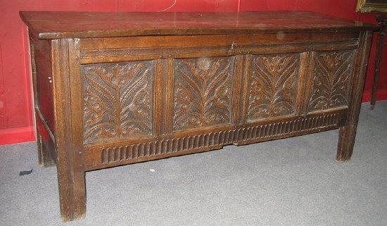 Appraisal: An early th Century carved oak coffer the planked top