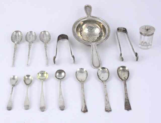 Appraisal: A two-handled silver tea strainer marks worn two pairs of