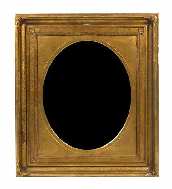 Appraisal: A Victorian Giltwood Mirror having an oval plate within a